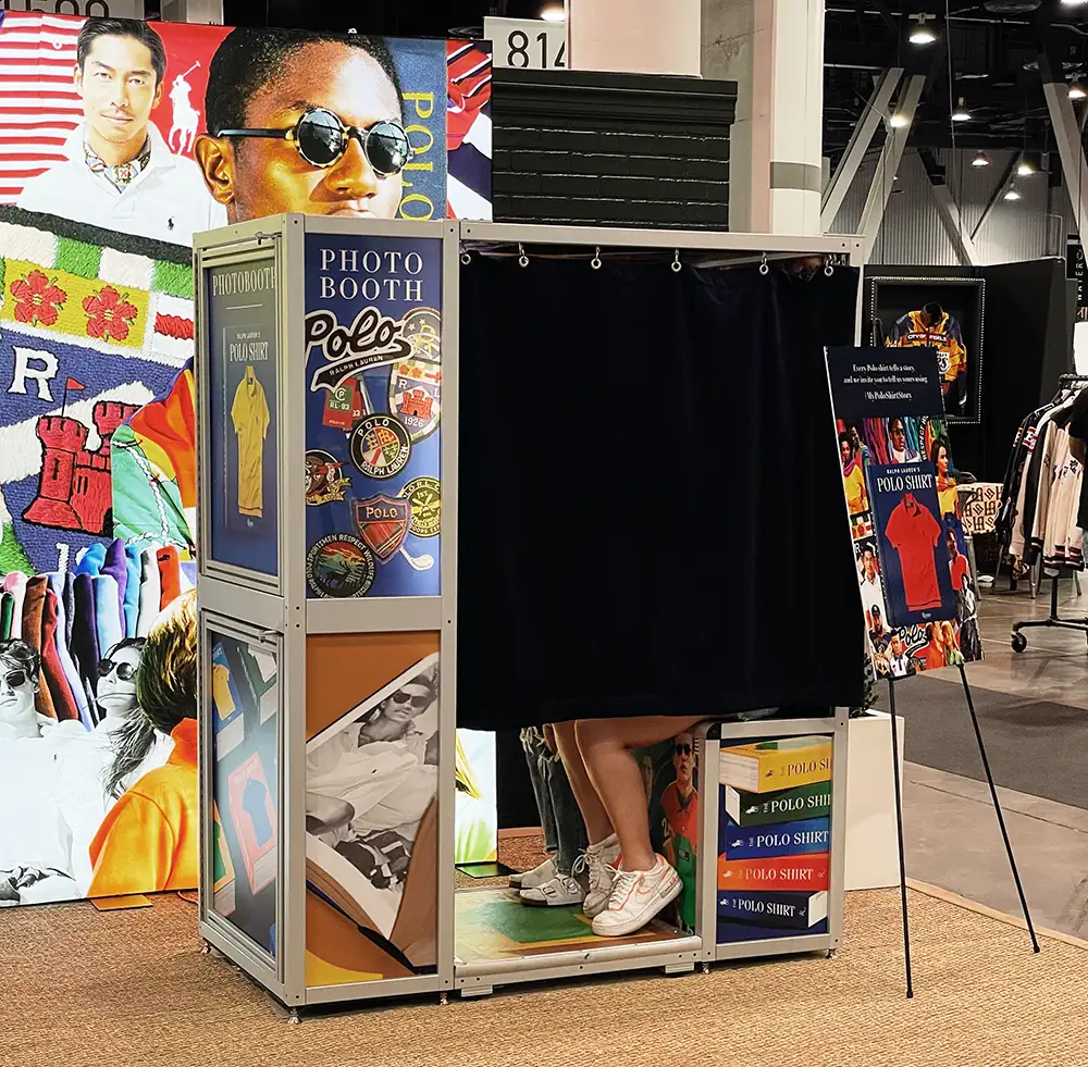 two people in a enclosed photo booth