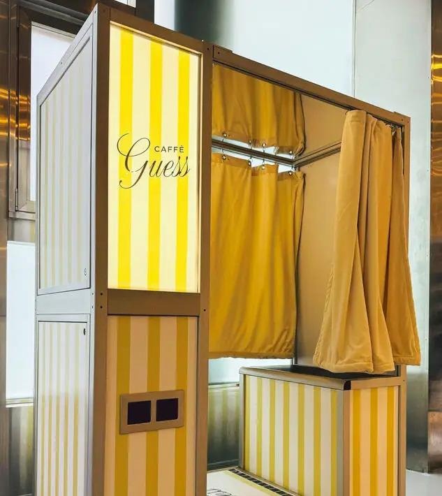 Photo-of a striped vintage photobooth for Caffe Guess showcasing experiential marketing for restaurants.