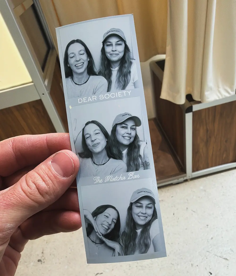 photo strip of two girls posing in a photo booth kansas city