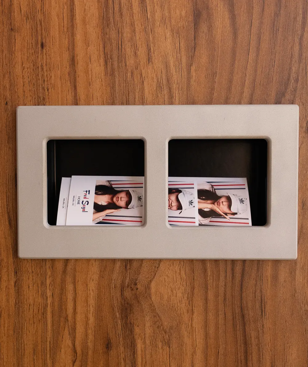 Close-up of the Majestic Photobooth print dispenser with two Fred Segal Home Malibu photo strips
