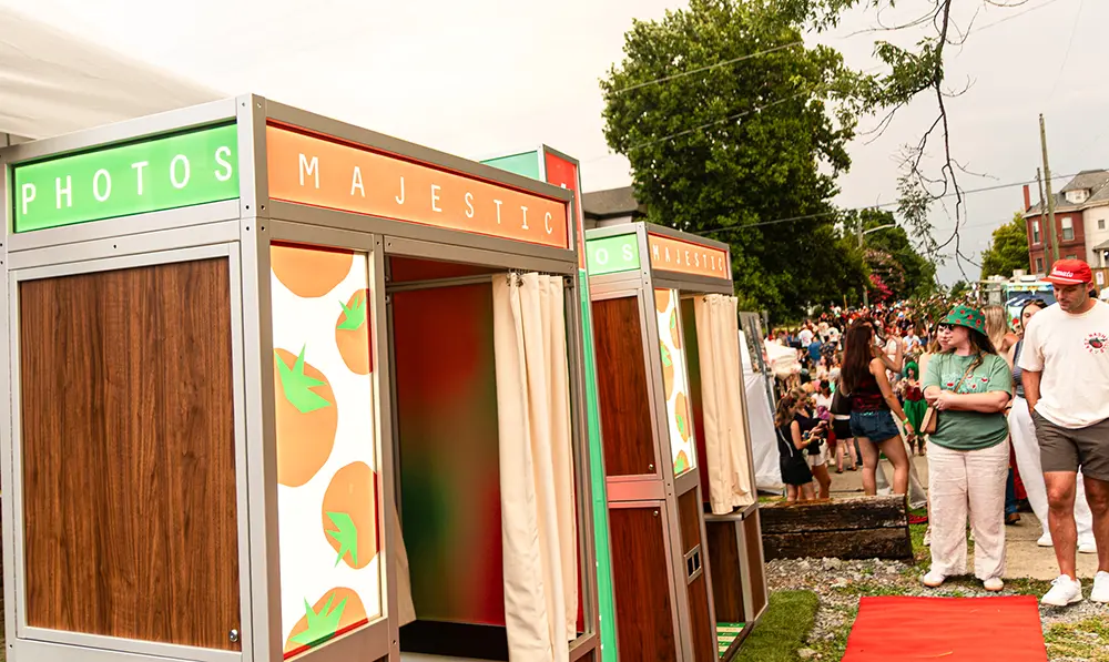 A line of people behind two classic photo booth