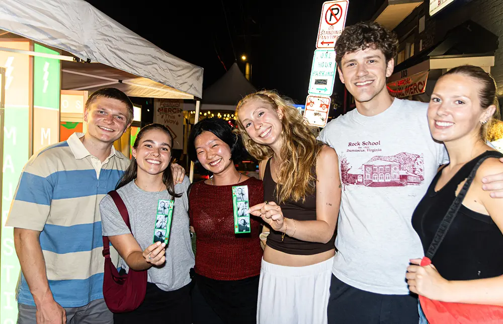 A group picture at a night time photo booth session.