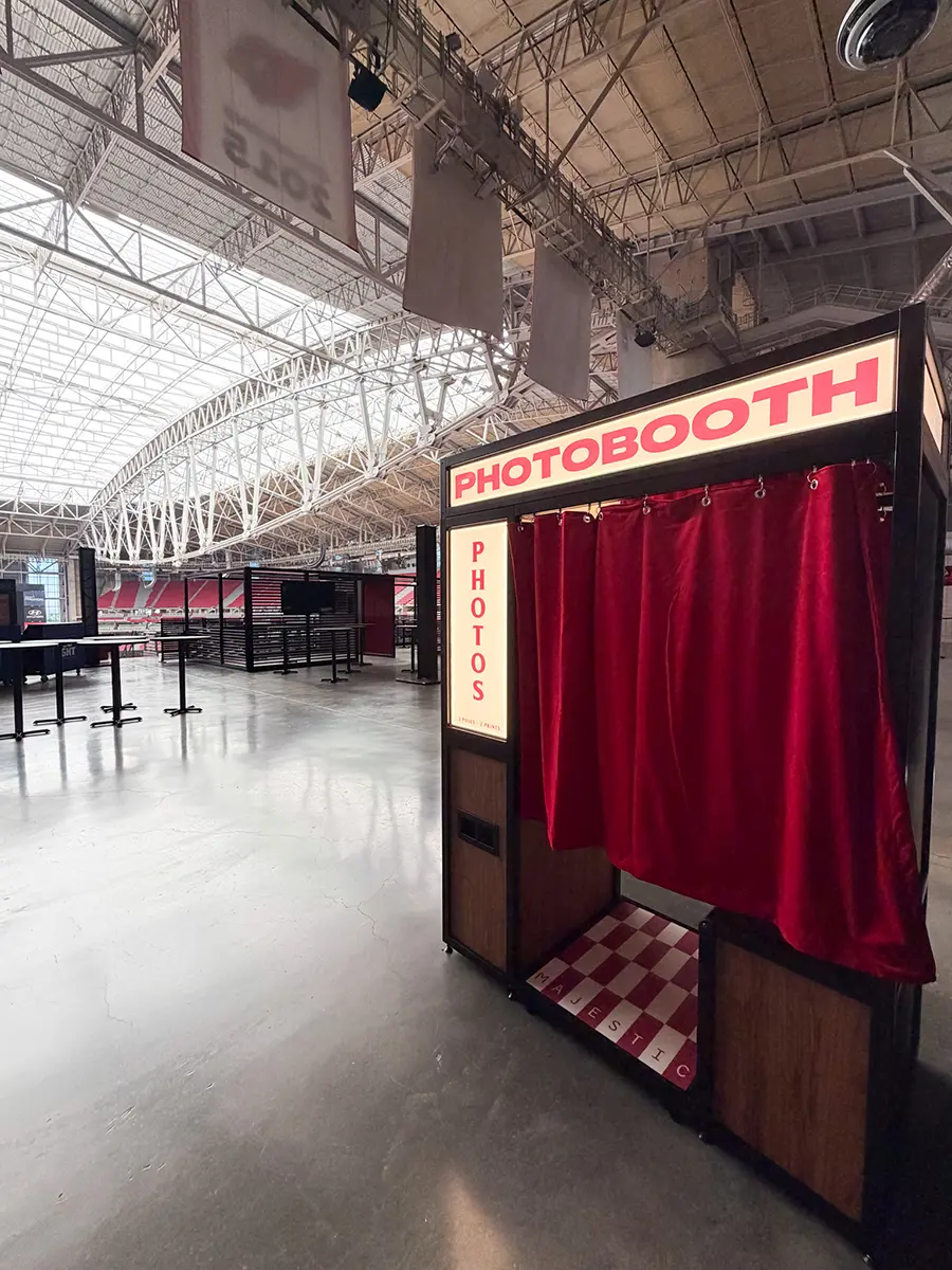 Arizona Cardinals photo booth with red velvet curtain and Majestic checkerboard floor plate at State Farm Stadium