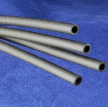 Four black, flexible tubes lying parallel on a blue surface. The tubes have a circular cross-section and appear to be made of a soft material.