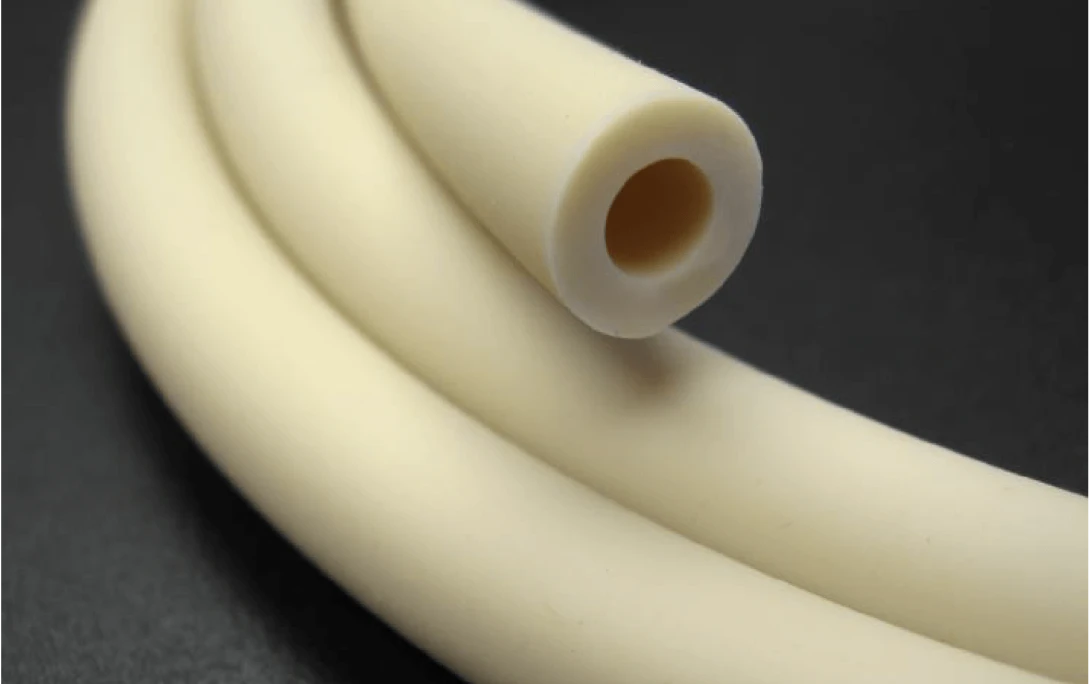 A close-up image of a white, flexible tube with a circular cross-section