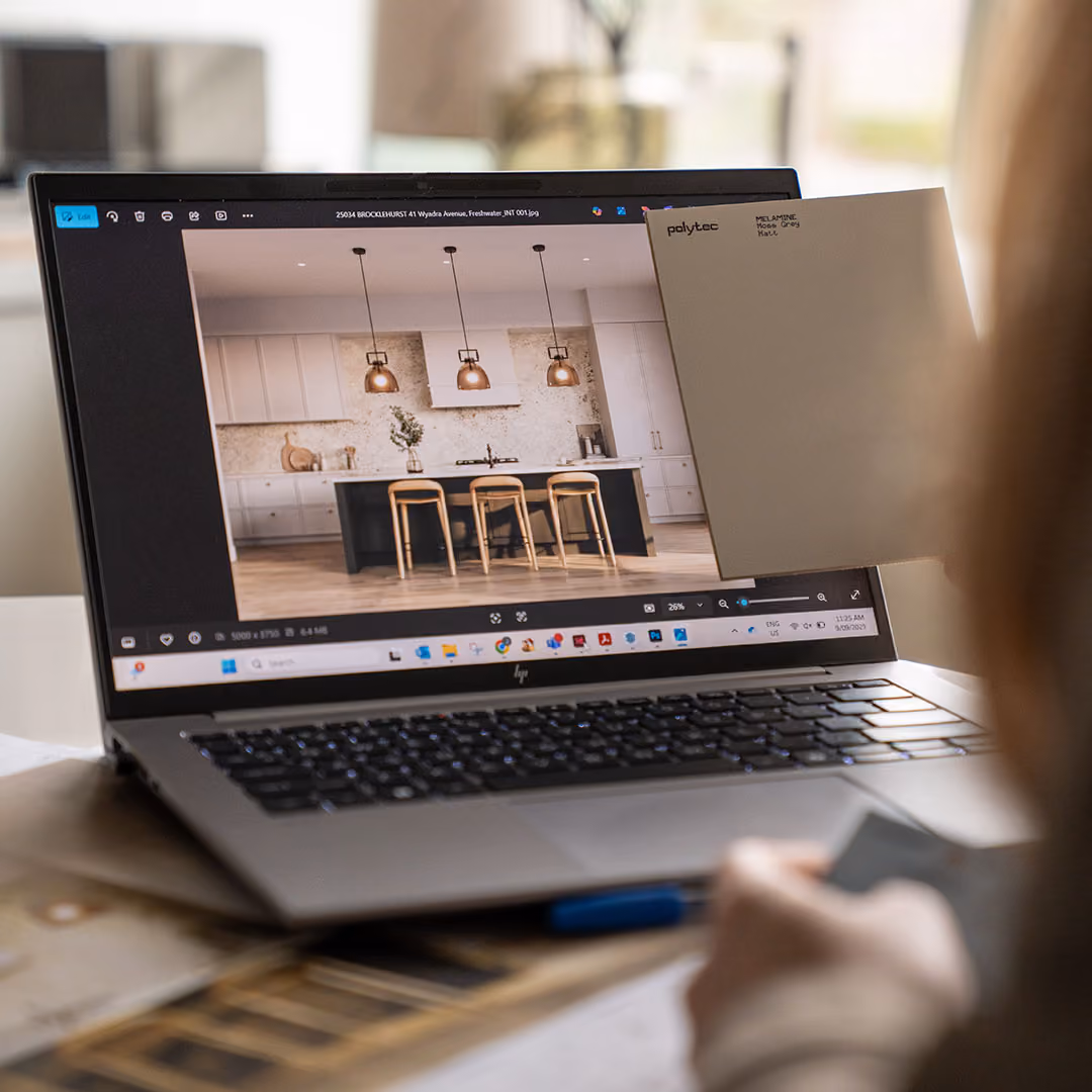 Person working on laptop showing home website design
