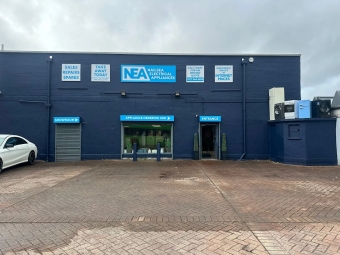 Tumble dryers displayed inside a modern appliance showroom