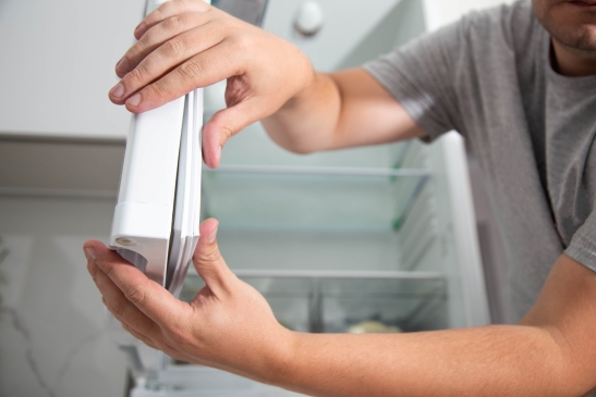 Appliance repair technician carrying out maintenance on a domestic appliance