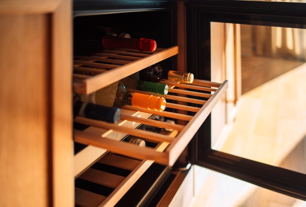 Modern wine cooler fridge with glass door, bottle shelving and digital temperature controls