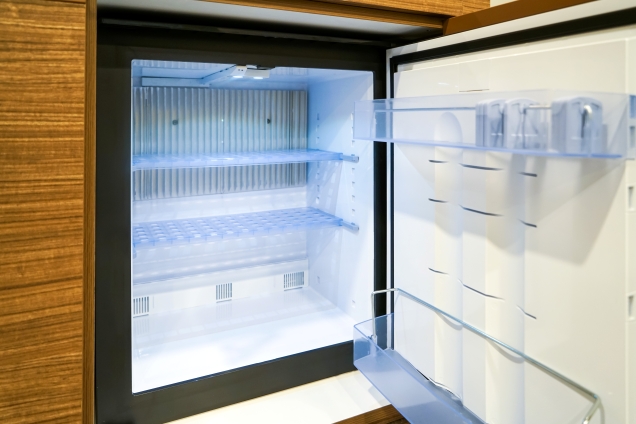 Compact minibar fridge providing convenient chilled drink storage in a modern guest room