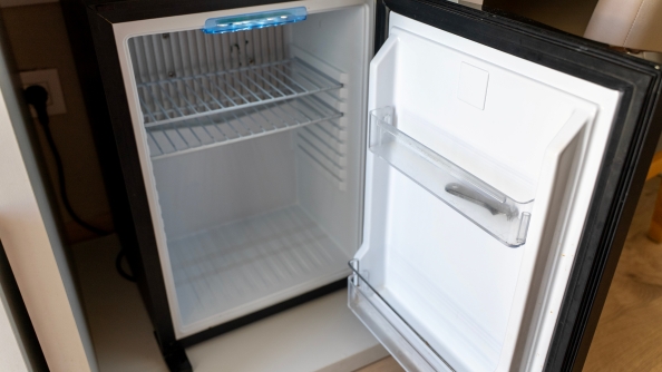 Compact minibar fridge installed in a contemporary hotel guest room