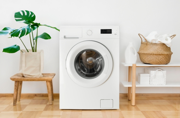 Freestanding front-loading washing machine positioned in a modern home utility room