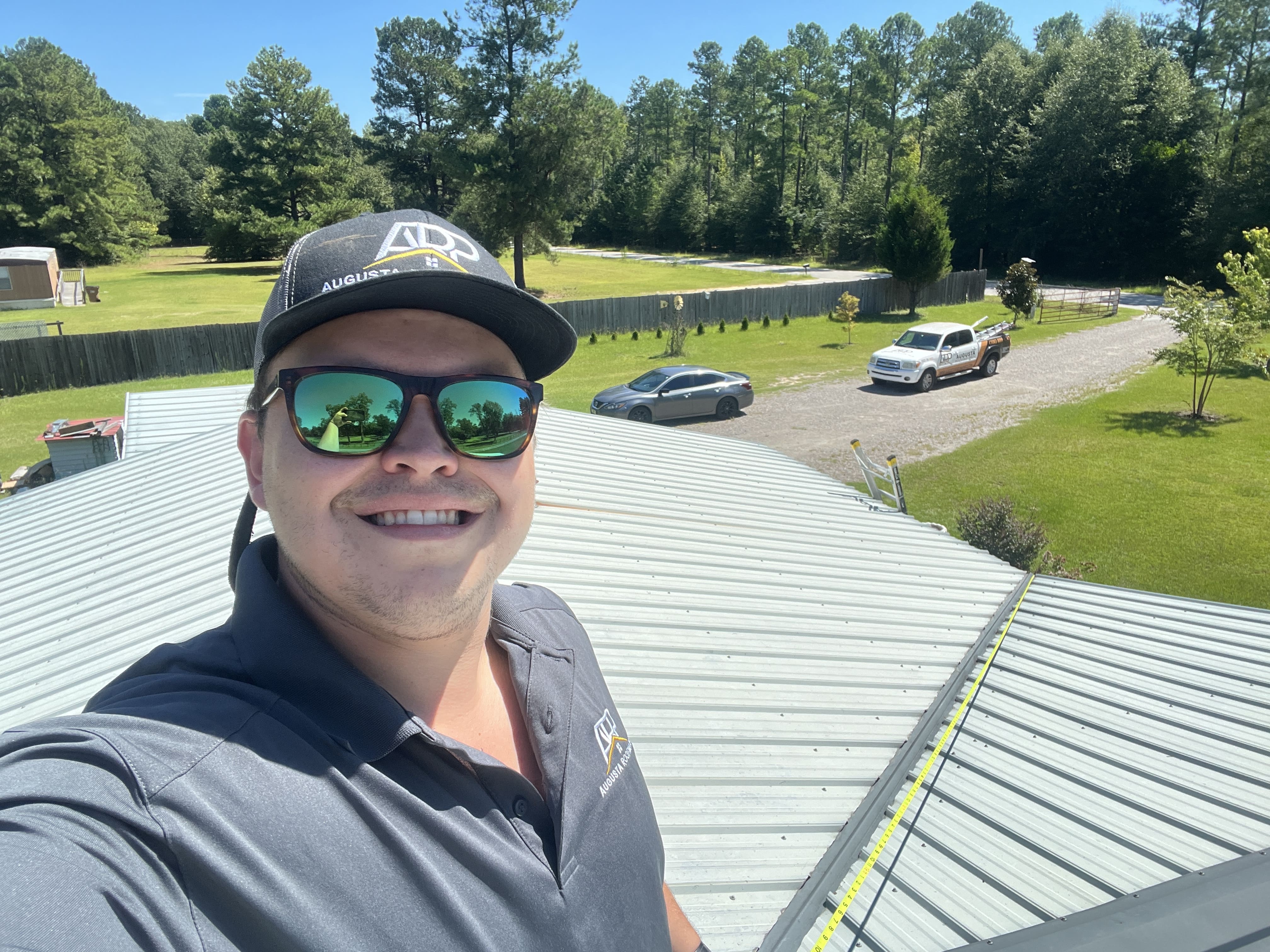 Experienced roofing business consultant inspecting completed metal roof installation