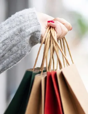 Woman's hand carrying shopping bags