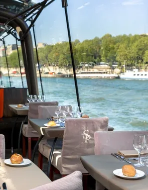 Tables with champagne glasses next to a pond