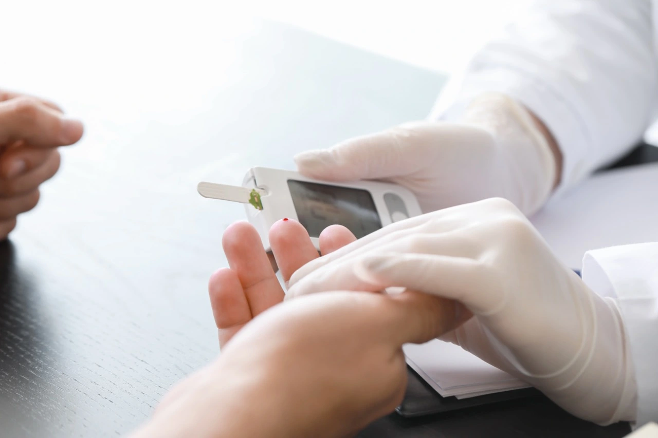 A pharmacist is about to take a blood sugar test.