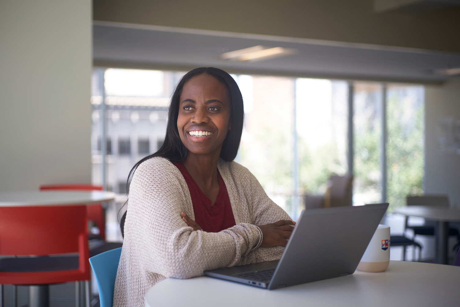 A female student working on her laptop in one of the lounge areas available at Bow Valley College.