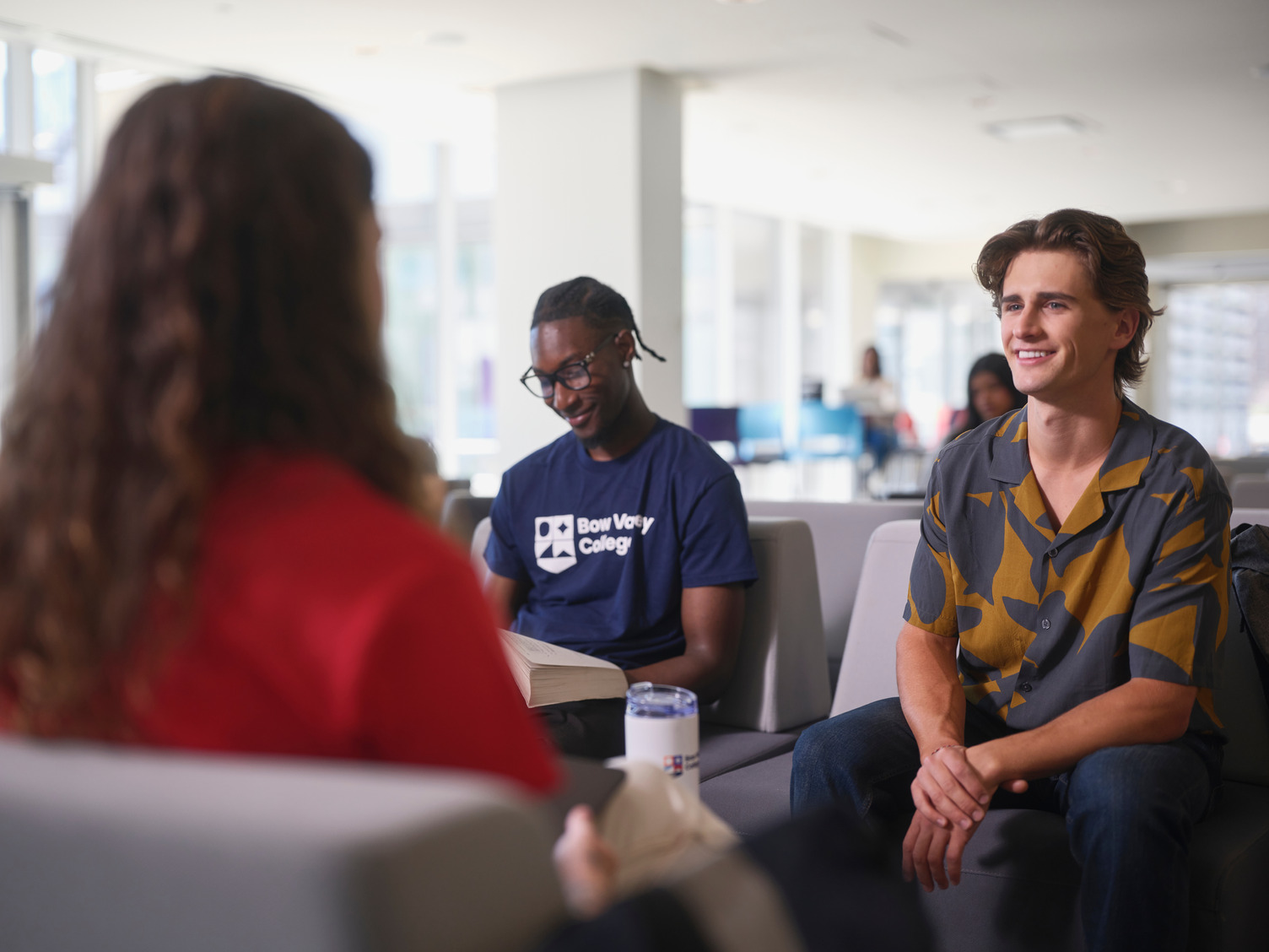 Students sitting together in one of lounge areas at Bow Valley College.