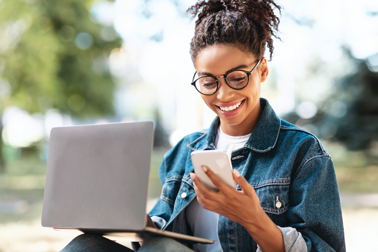 A young woman on her laptop and phone