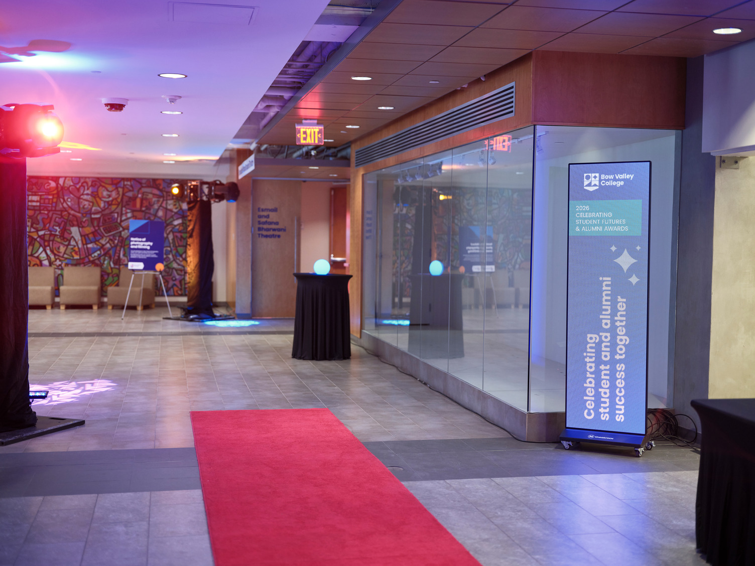 Bow Valley College first floor north campus hallway decorated for the Alumni Awards with a red carpet, bright lights and signage
