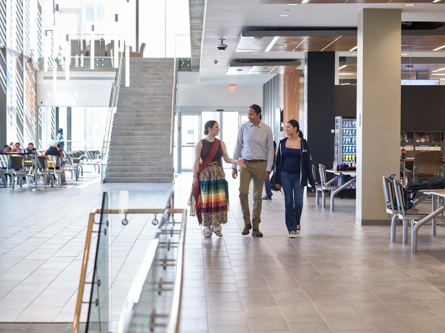 Three students walking together down the hallway in Bow Valley College.