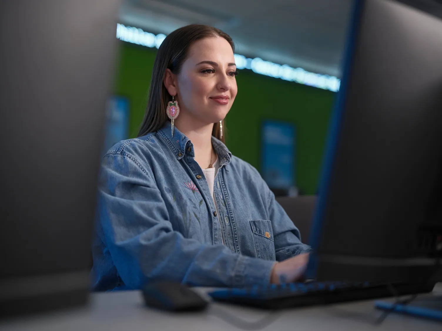 A female student working on one of the computers at one of Bow Valley College's computer lab