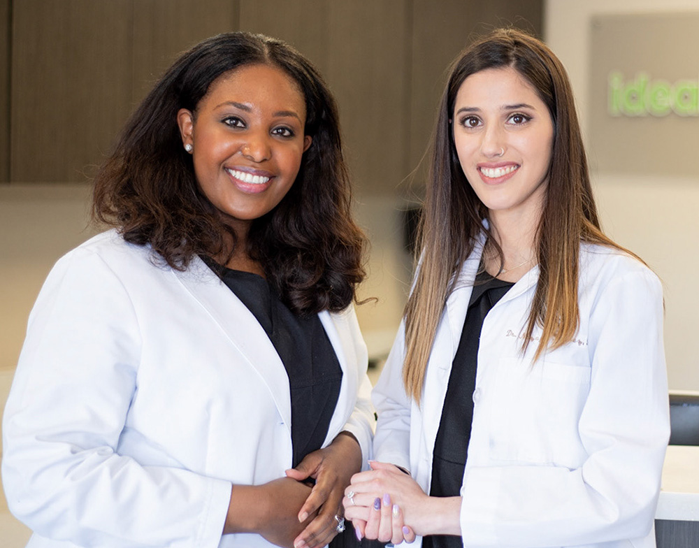 Smiling Ideal Dental clinician holding a clipboard in a dental clinic