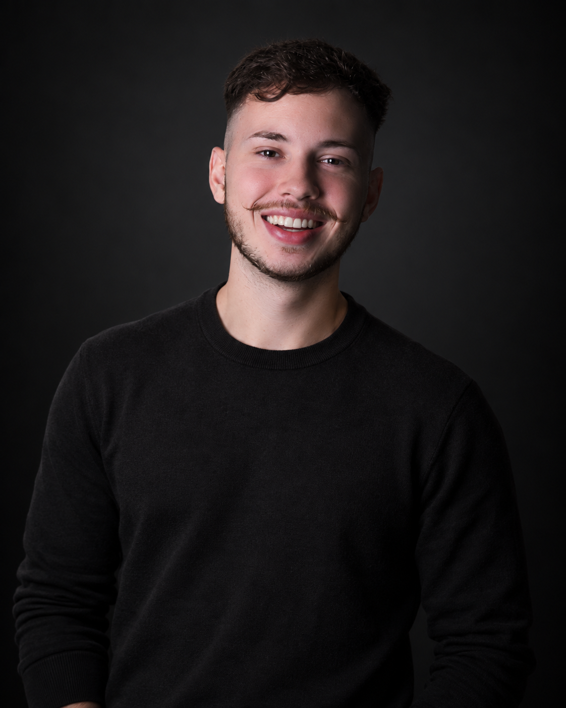 Retrato de Endriu Wacheski em fundo escuro, vestindo preto.