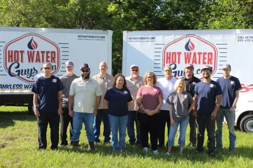 The Hot Water Guys team in front of their service trucks in Houston