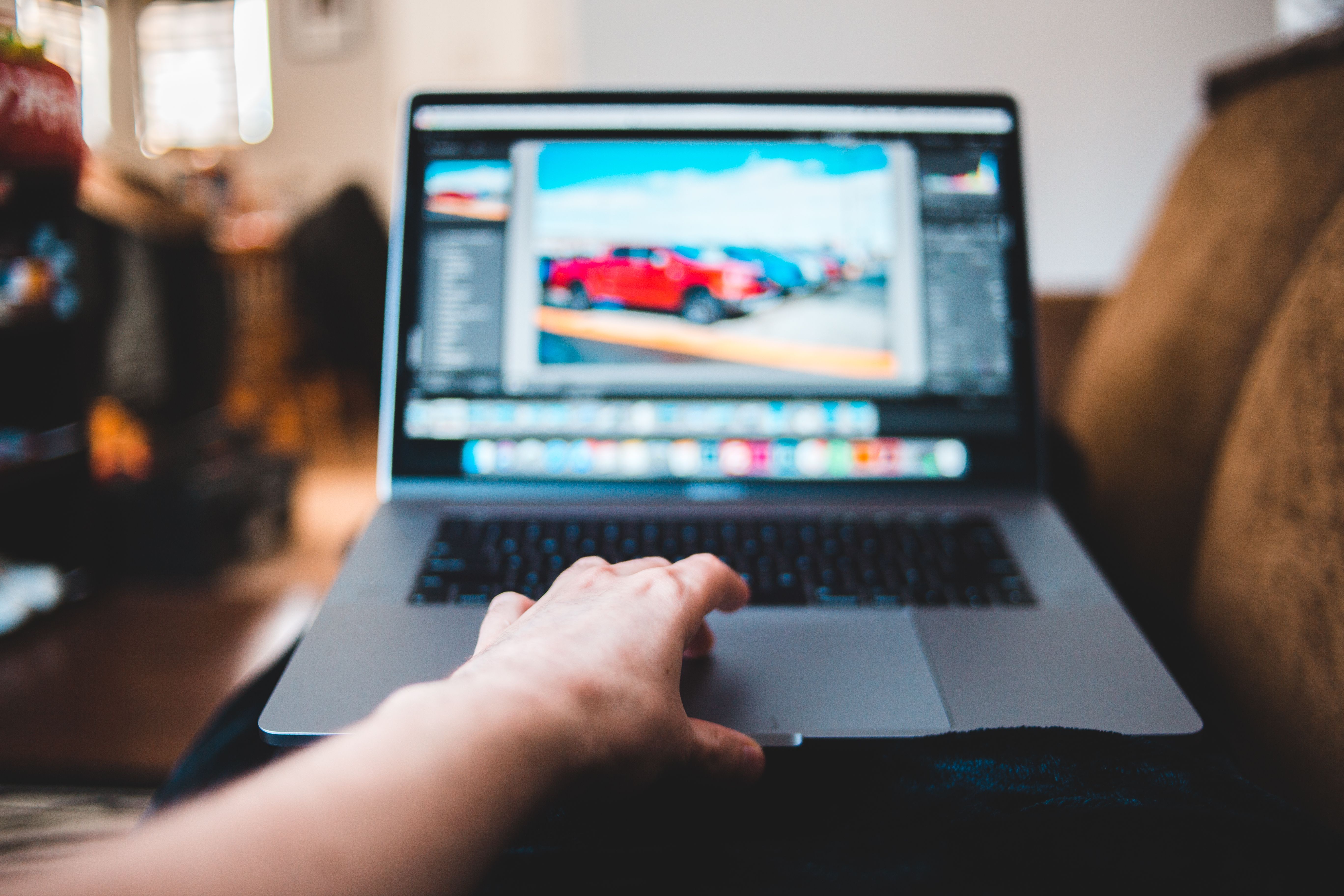 A person editing photos on a laptop at home