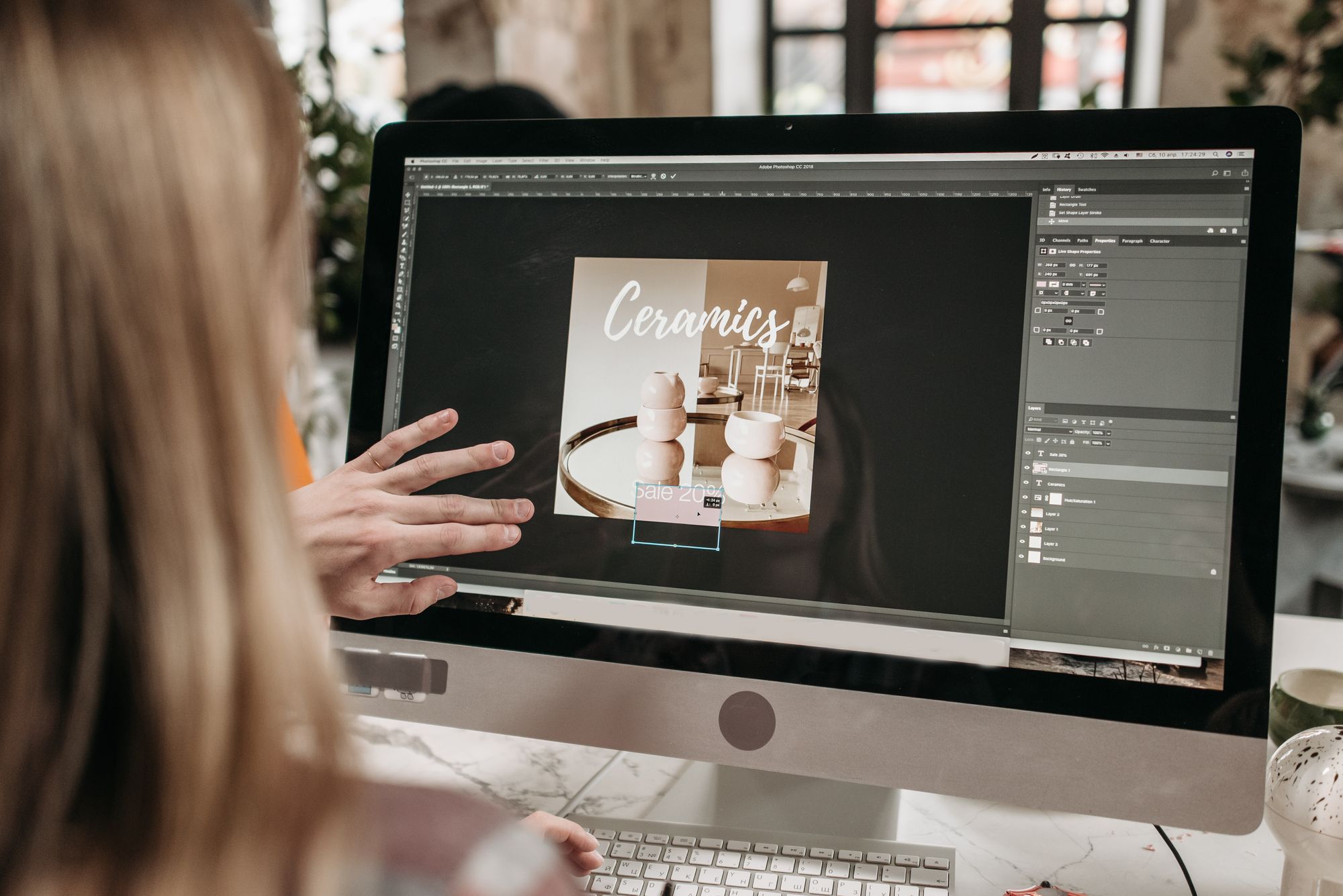A designer working on a graphic design layout