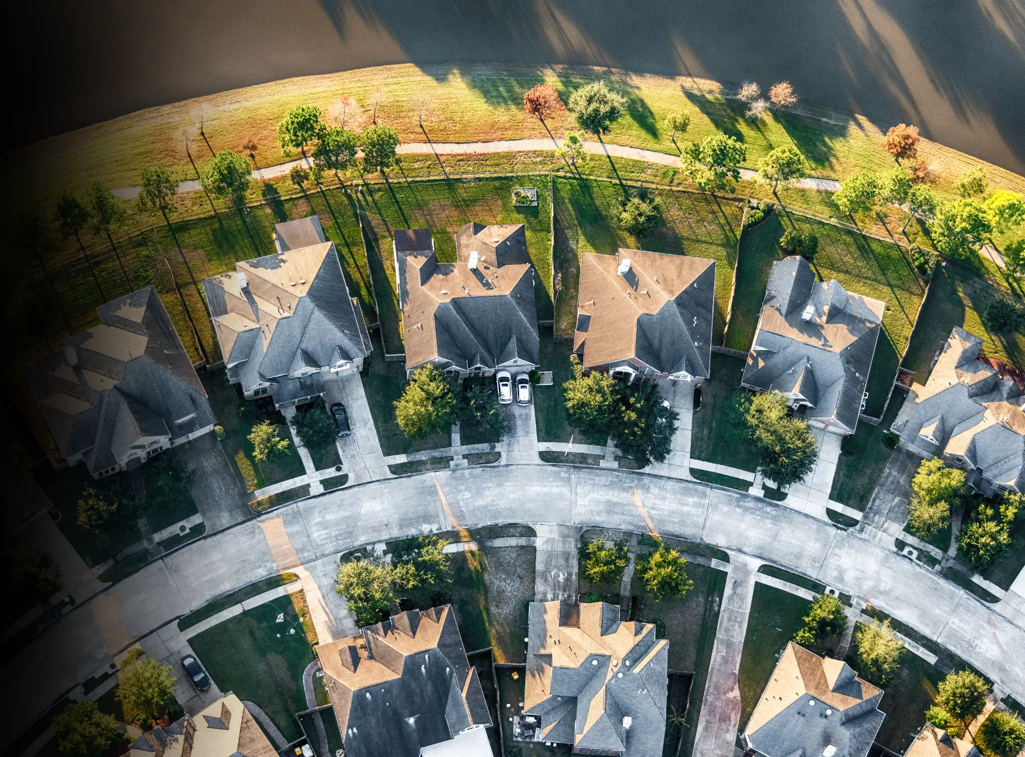 A view of a residential area with houses and trees.