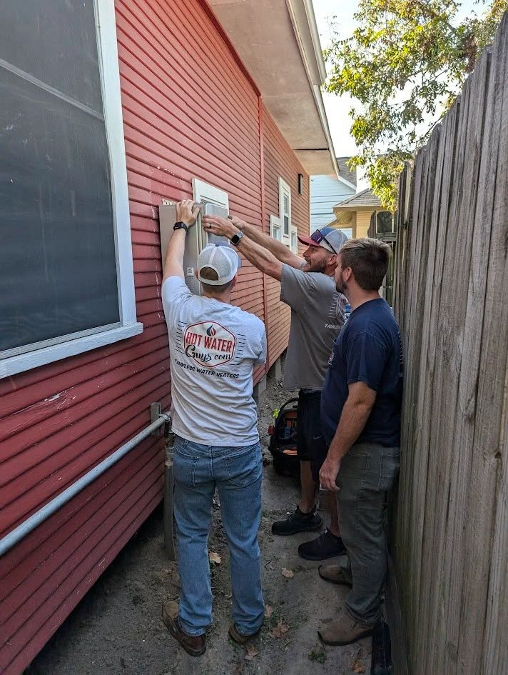 Hot Water Guys team installing a tankless water heater