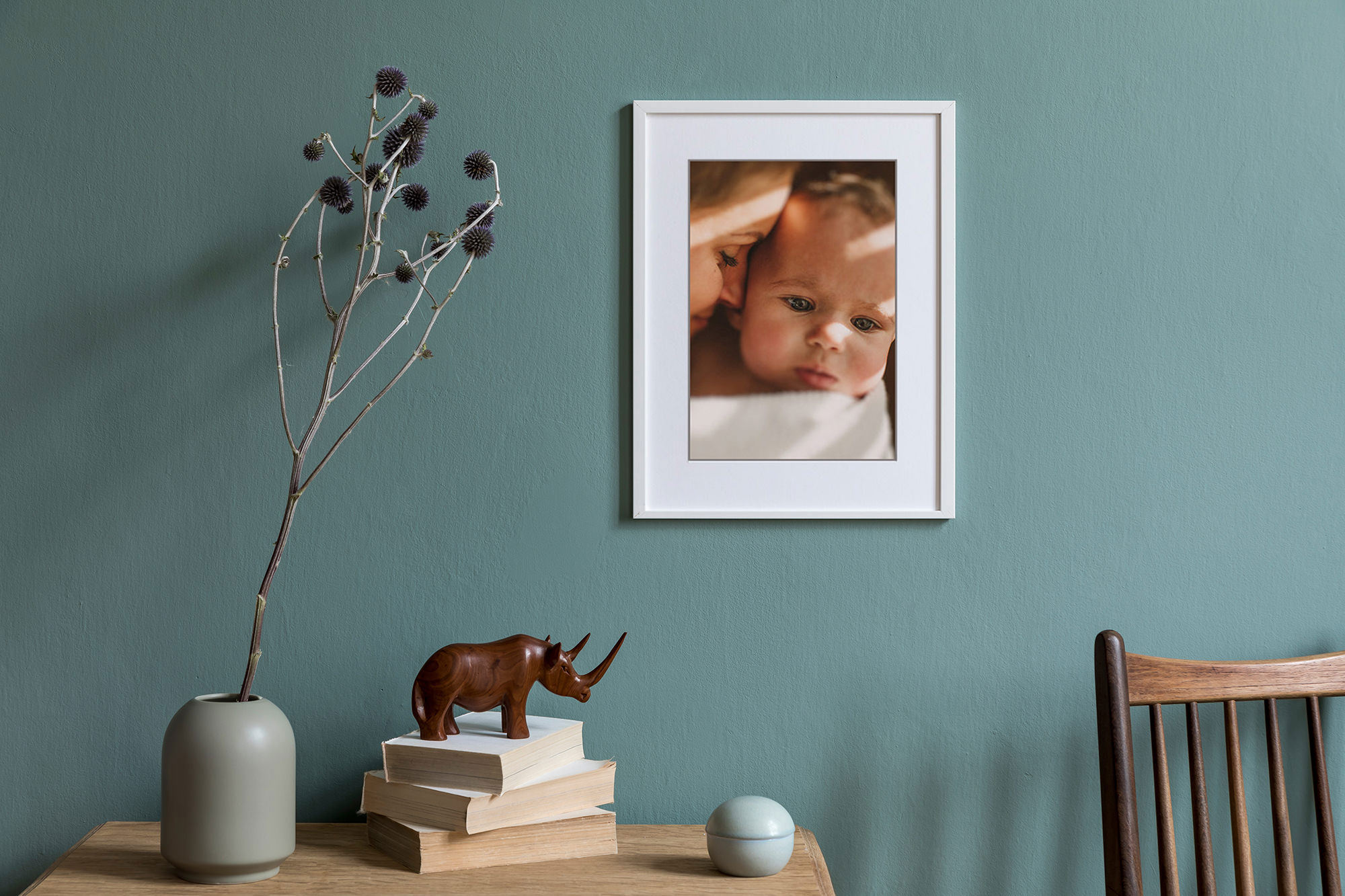 Framed family photograph displayed on a green wall in a styled interior