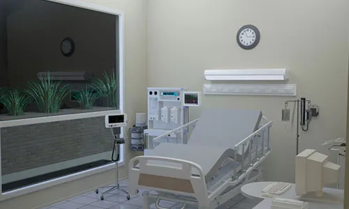 A hospital room with a bed, chair, and a clock.