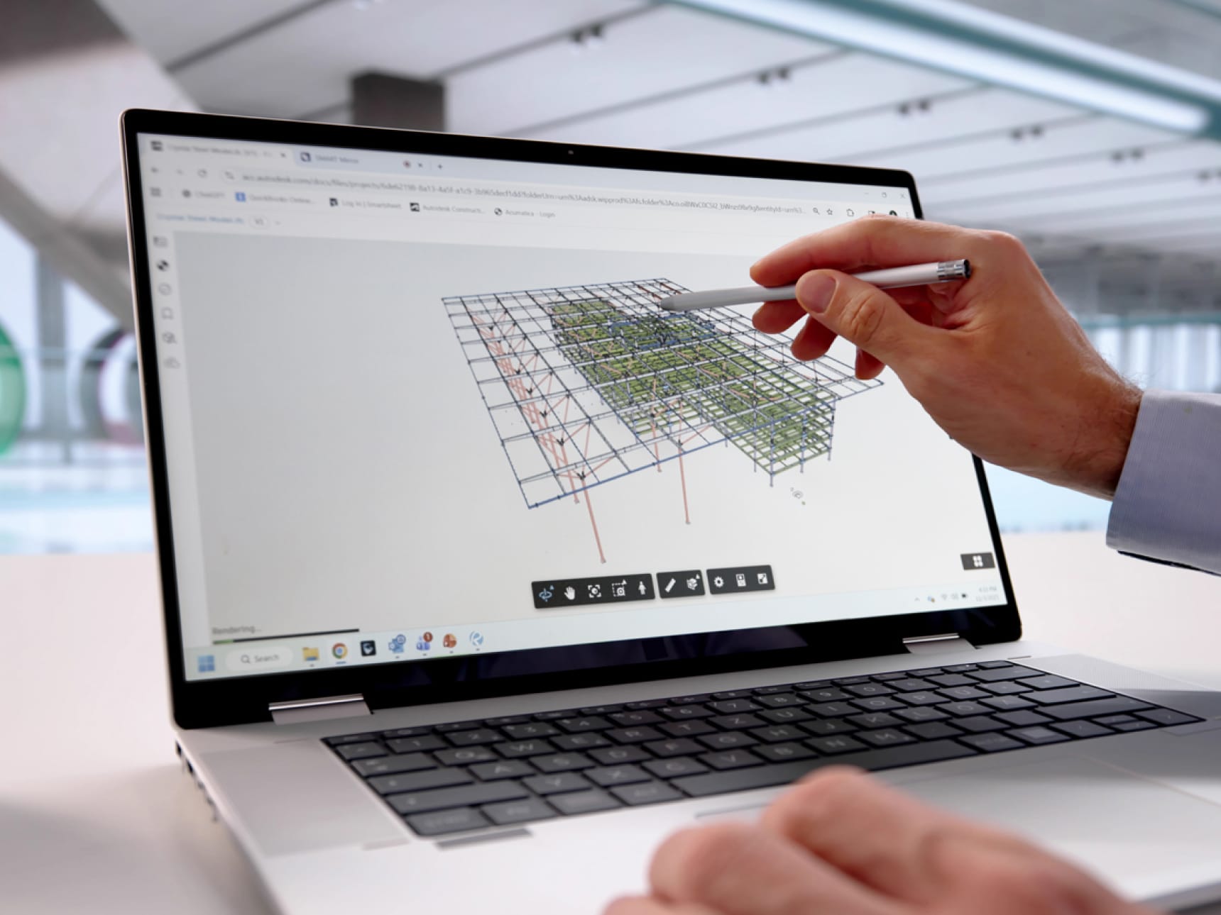 Person using a stylus to interact with a 3D architectural model on a laptop screen.