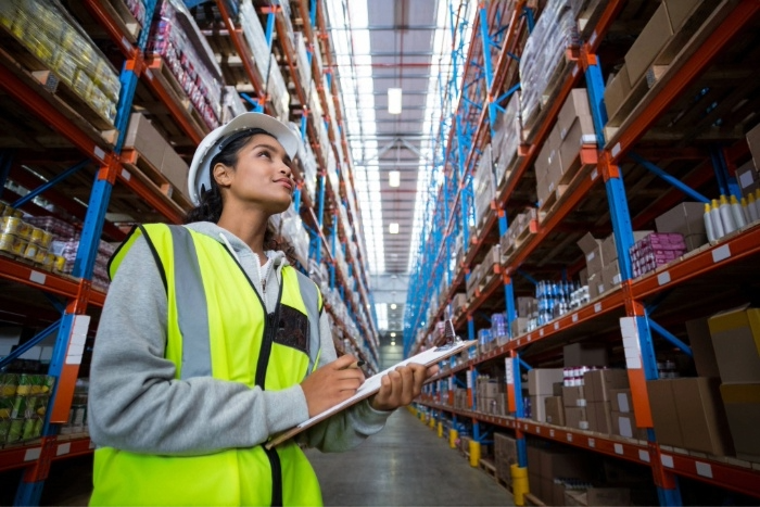lady wearing a hard hat in a warehouse