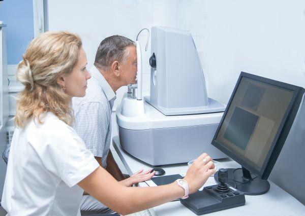 Optometrist Performing Eye Exam on Patient using machine