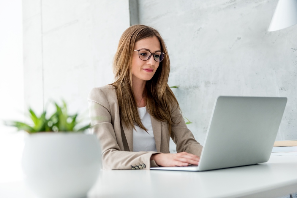 Professional Woman Wearing Glasses Using Laptop