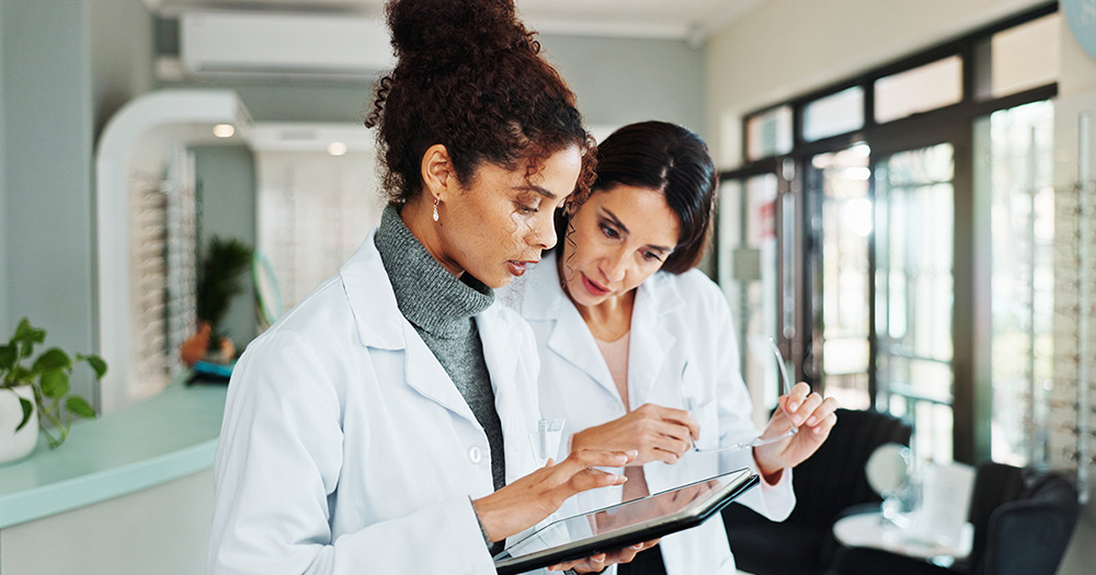 optometrists view exam record on tablet