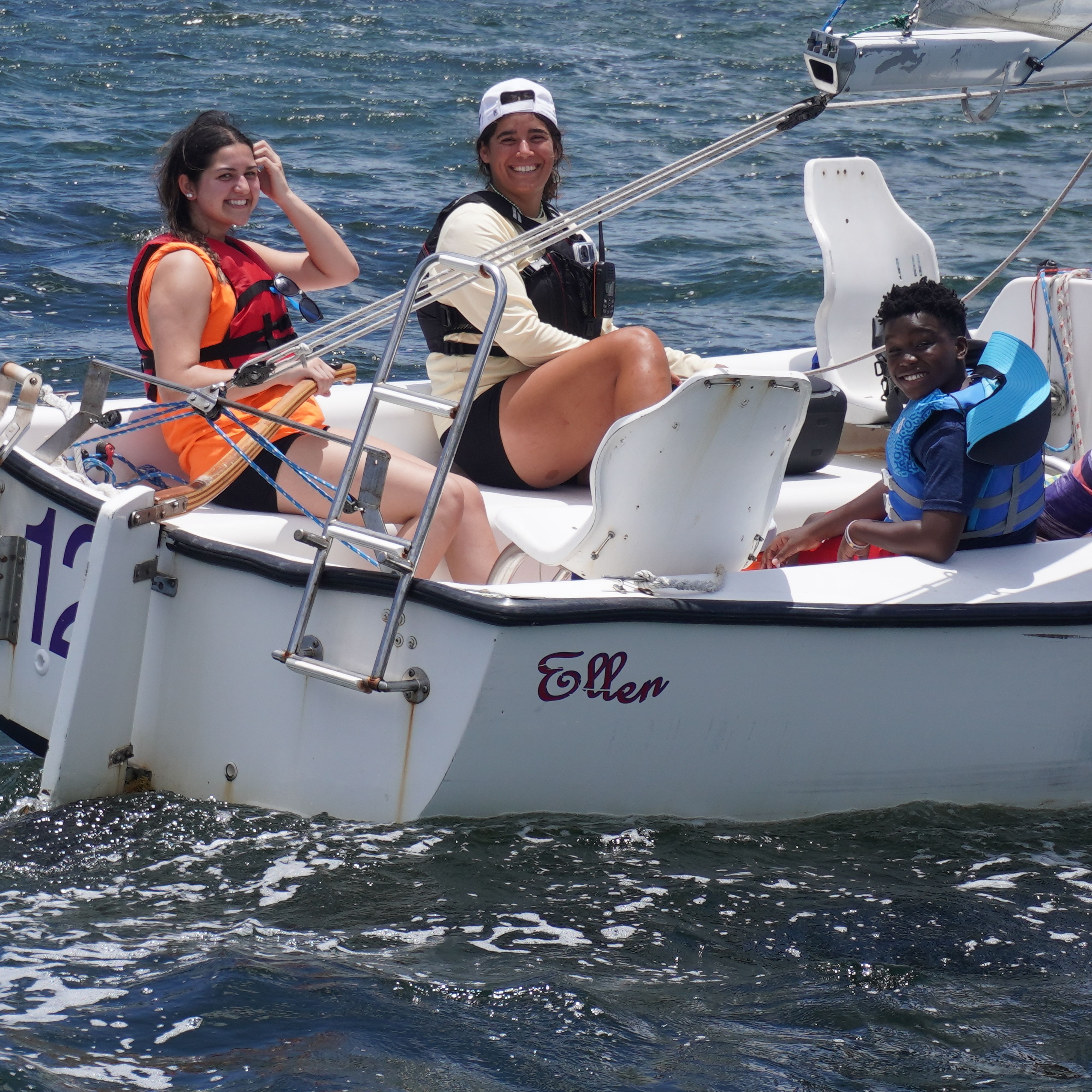Sailors aboard an adaptive sailboat
