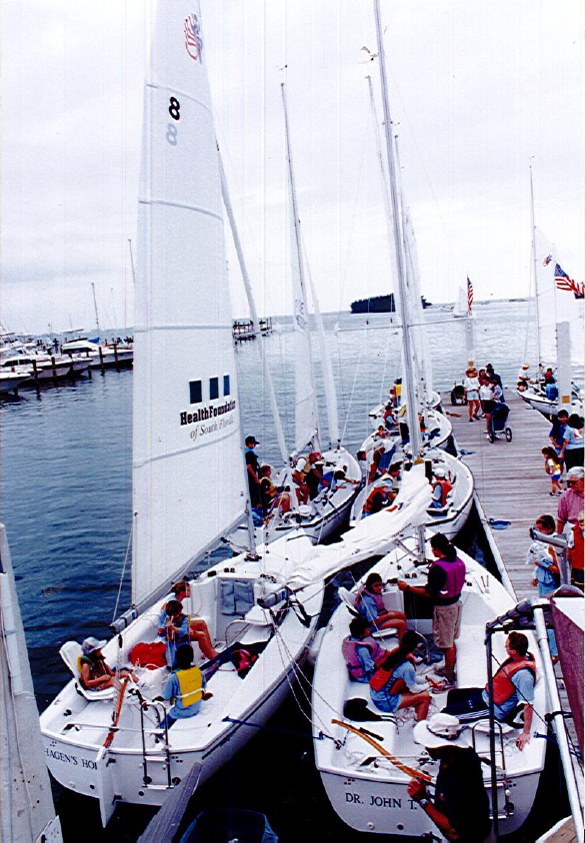 A fleet of sailboats crewed by young sailors leaving the Shake-A-Leg Miami docks