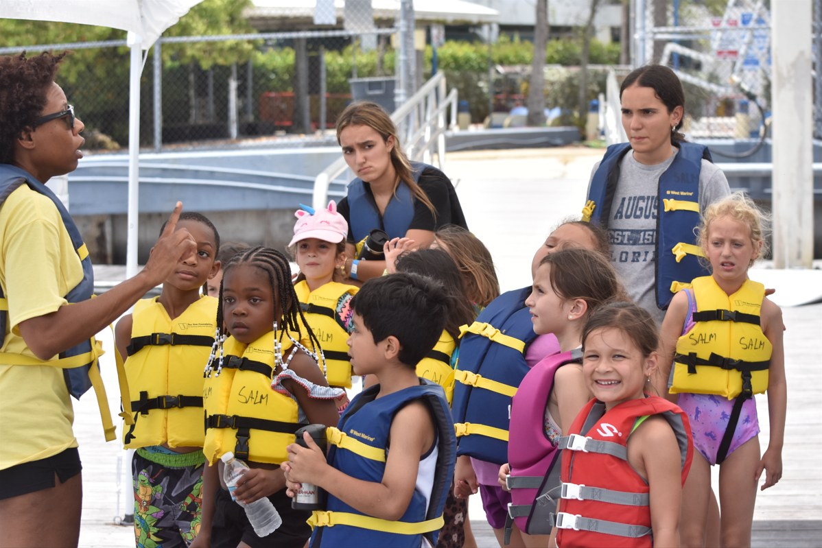 A group of campers in life jackets on the Shake-A-Leg Miami dock