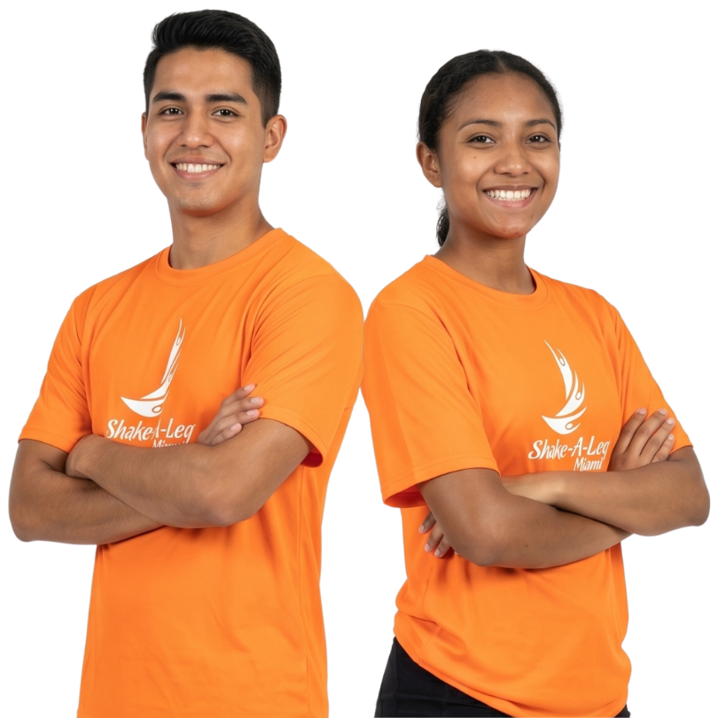 Two Shake-A-Leg Miami staff members in orange program shirts
