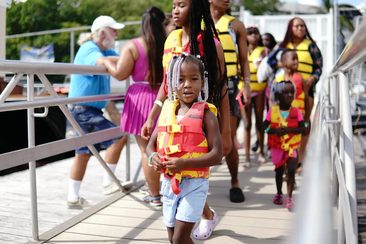 Children in life jackets walking down the accessible ramp to the Shake-A-Leg Miami dock