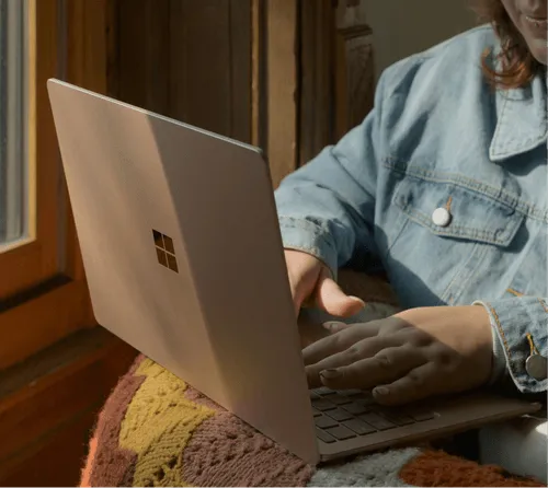 A person typing something on a laptop