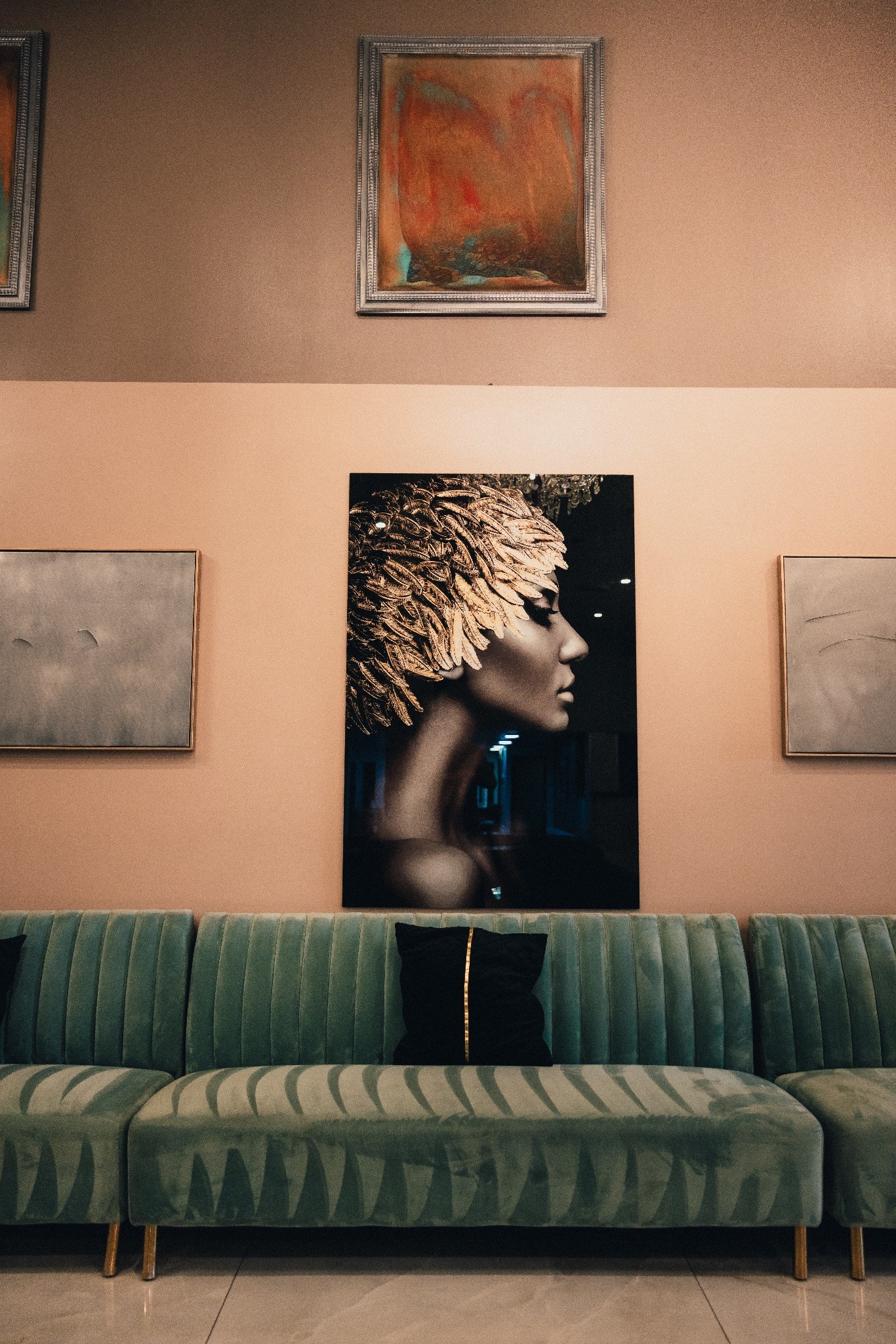 Artwork above green velvet seating at The Lexi