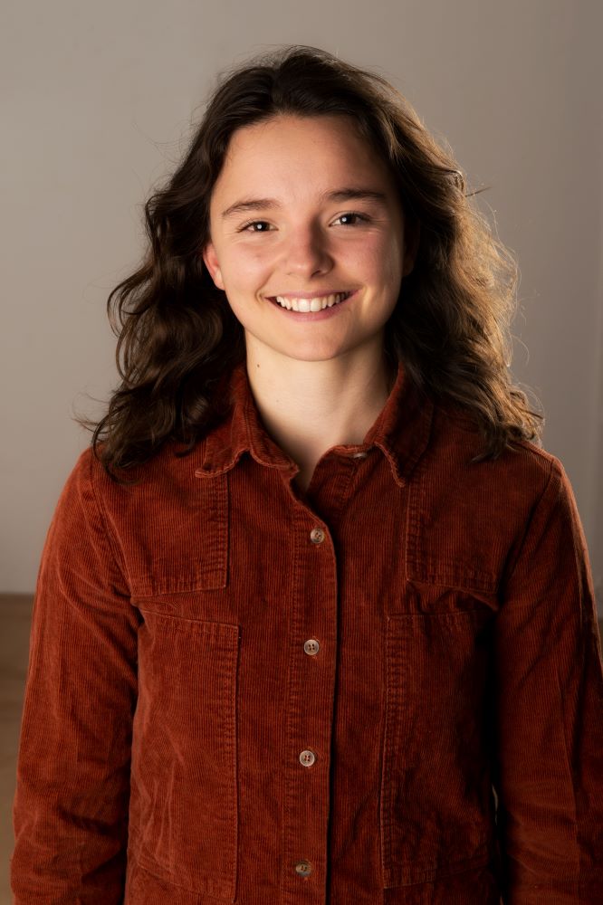 Headshot of a white woman with long brown hair