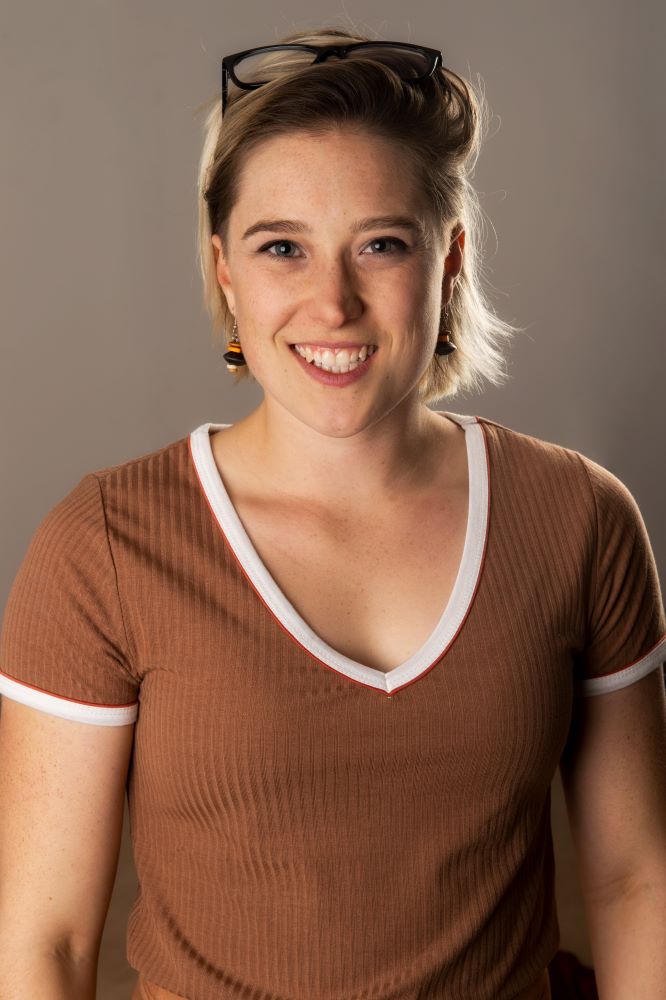 A headshot of a white woman witch blonde hair and glasses
