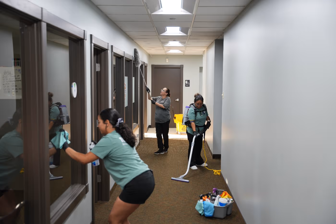 Top Tier Environmental Service workers performing a commercial cleaning service in office space
